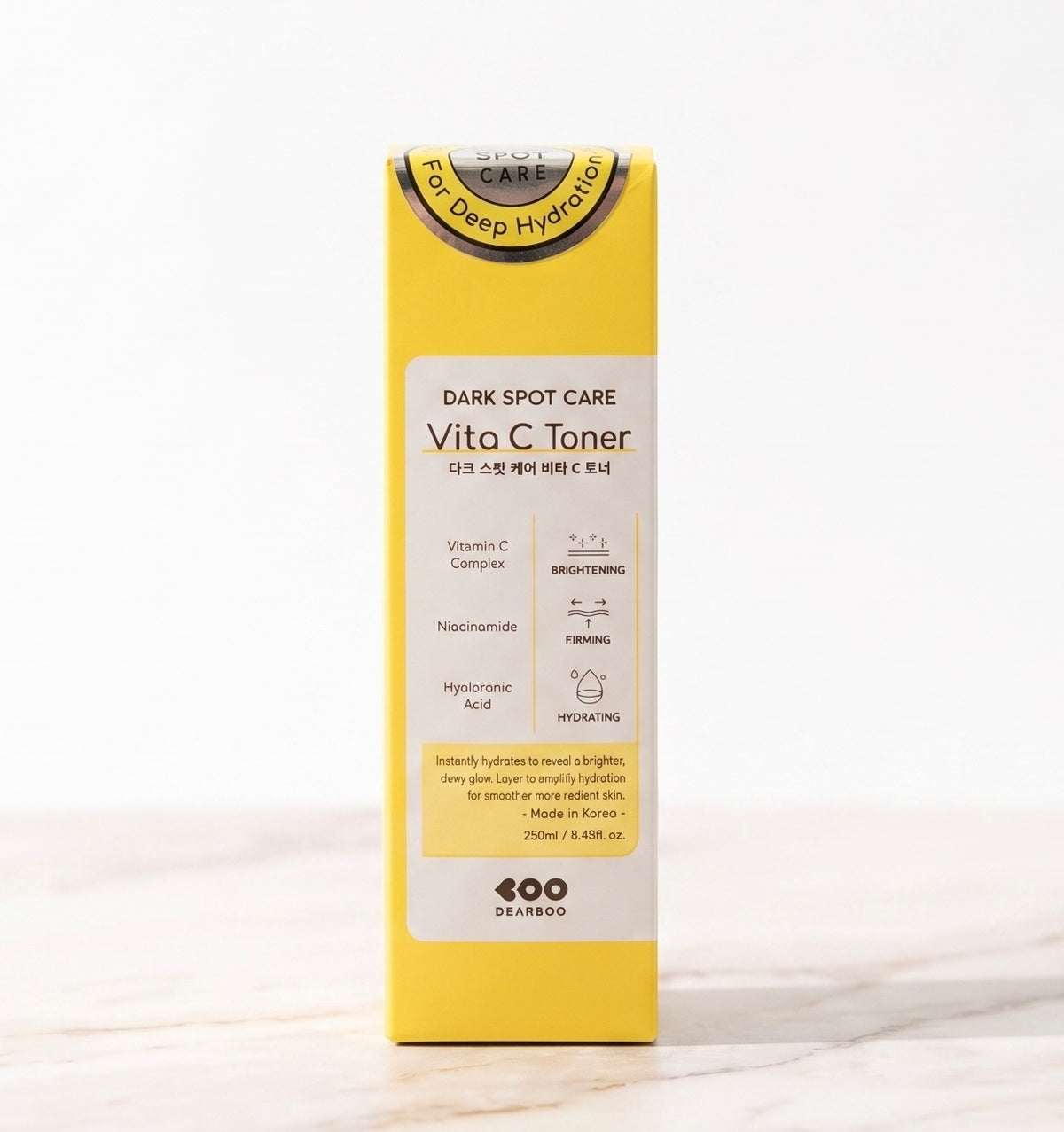 A yellow box of 400 24 Hours Vita C Toner Dark Spot Care, standing upright on a light marble surface against a white background.