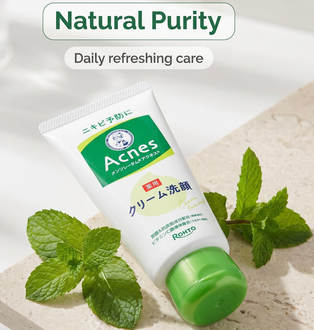A tube of Rohto Acnes cream cleanser is displayed on a light stone surface with fresh mint leaves. The top of the image features text overlays reading 'Natural Purity' and 'Daily refreshing care'.