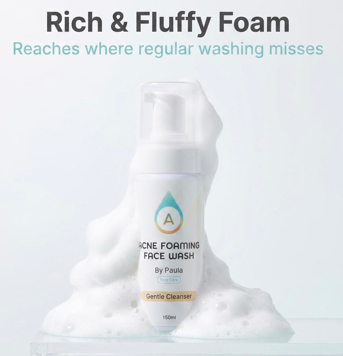 A bottle of acne foaming face wash by Paula, surrounded by abundant white foam, with promotional text at the top reading 'Rich & Fluffy Foam'.