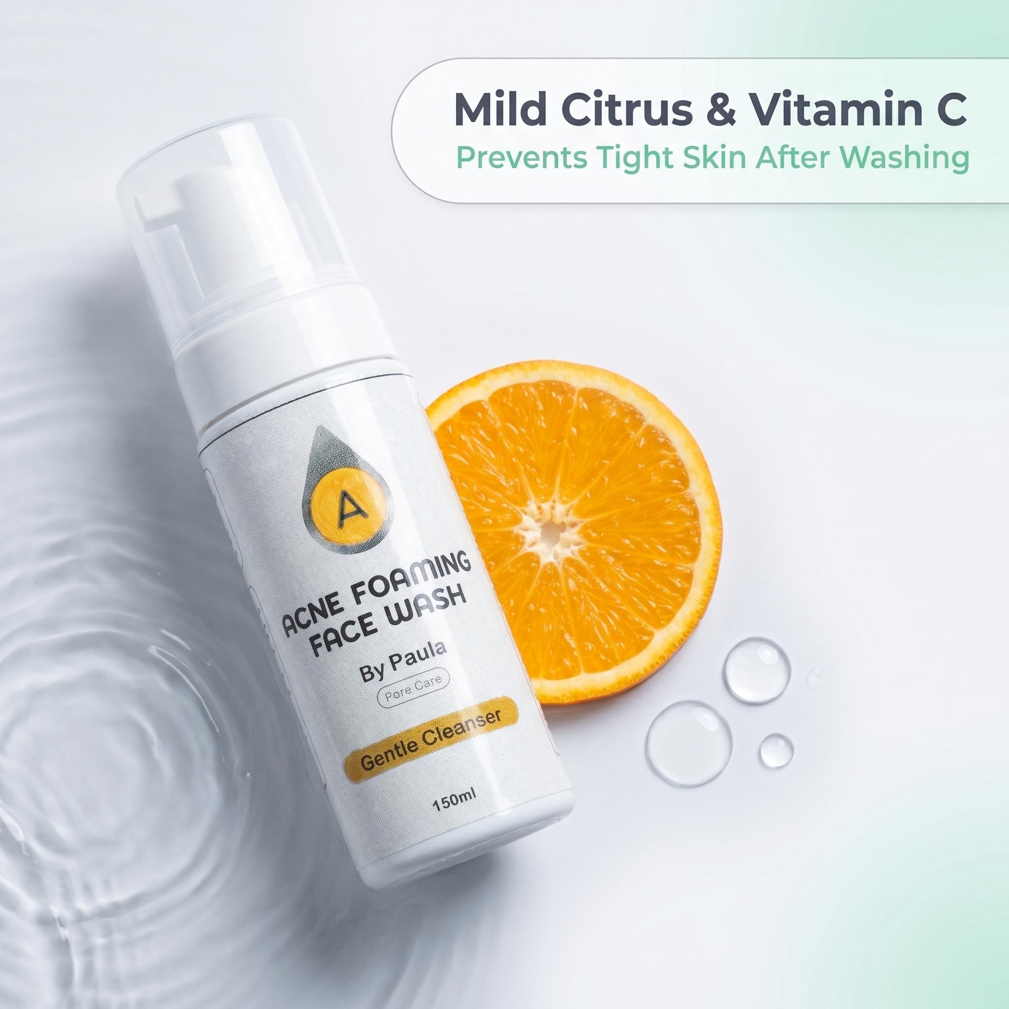 A bottle of acne foaming face wash by Paula, styled with a sliced orange and water droplets on a light background with text overlay.