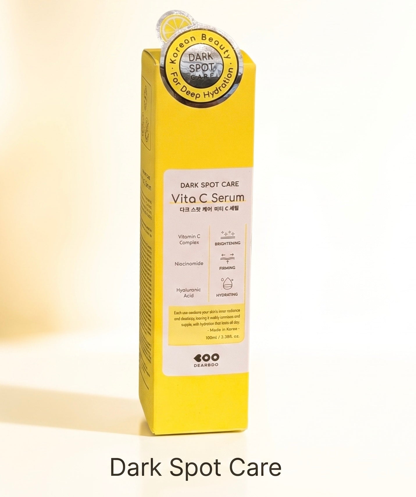 A tall yellow skincare box labeled 'DARK SPOT CARE Vita C Serum' with a white front panel and a circular seal near the top, shown on a light beige background with the text 'Dark Spot Care' below.