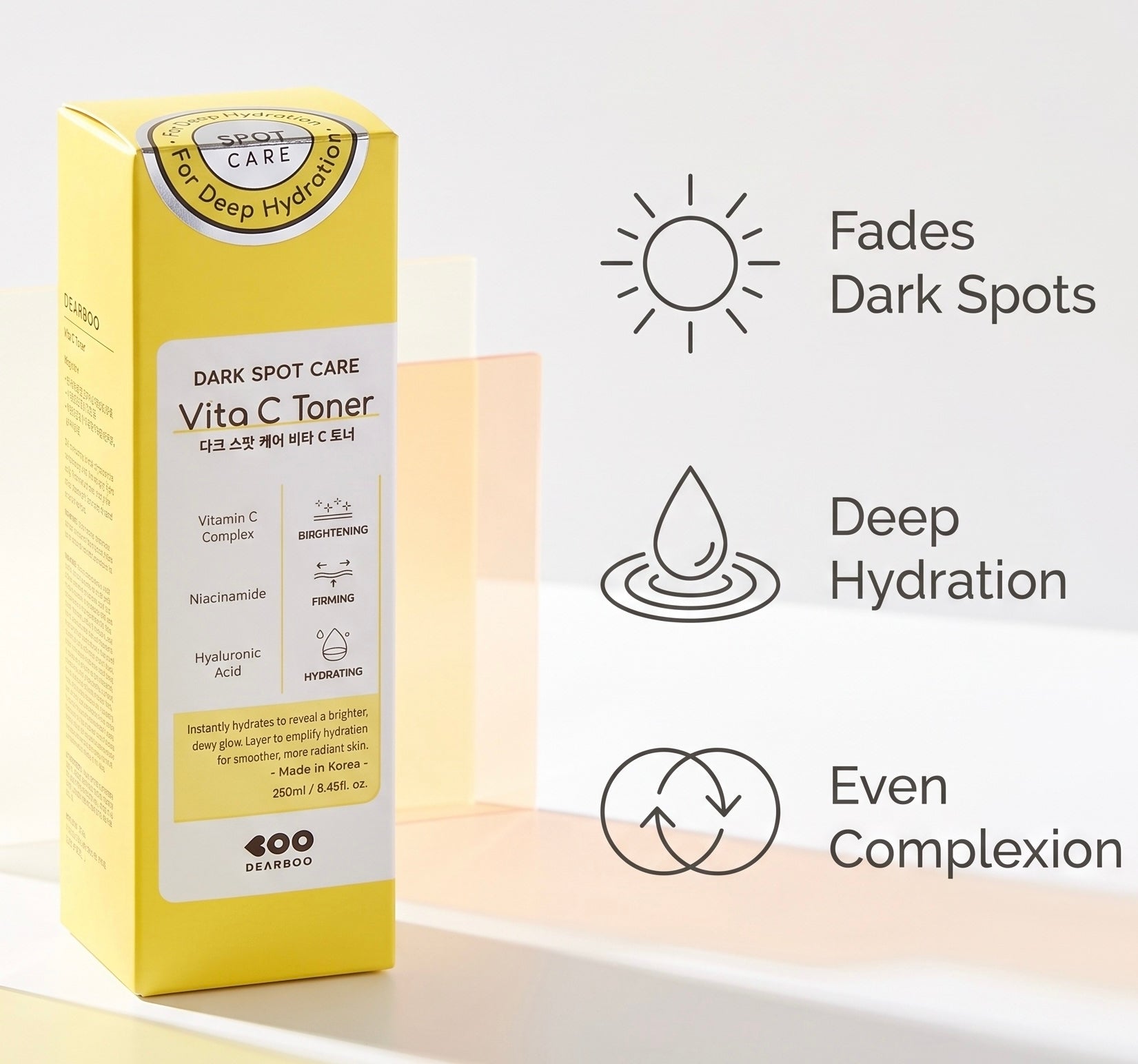 A yellow box of Soo Beruby Vita C Toner Dark Spot Care stands on a white surface against a light beige background. To the right are three black line icons with text: a sun reading 'Fades Dark Spots,' a water droplet reading 'Deep Hydration,' and a circular arrow reading 'Even Complexion.