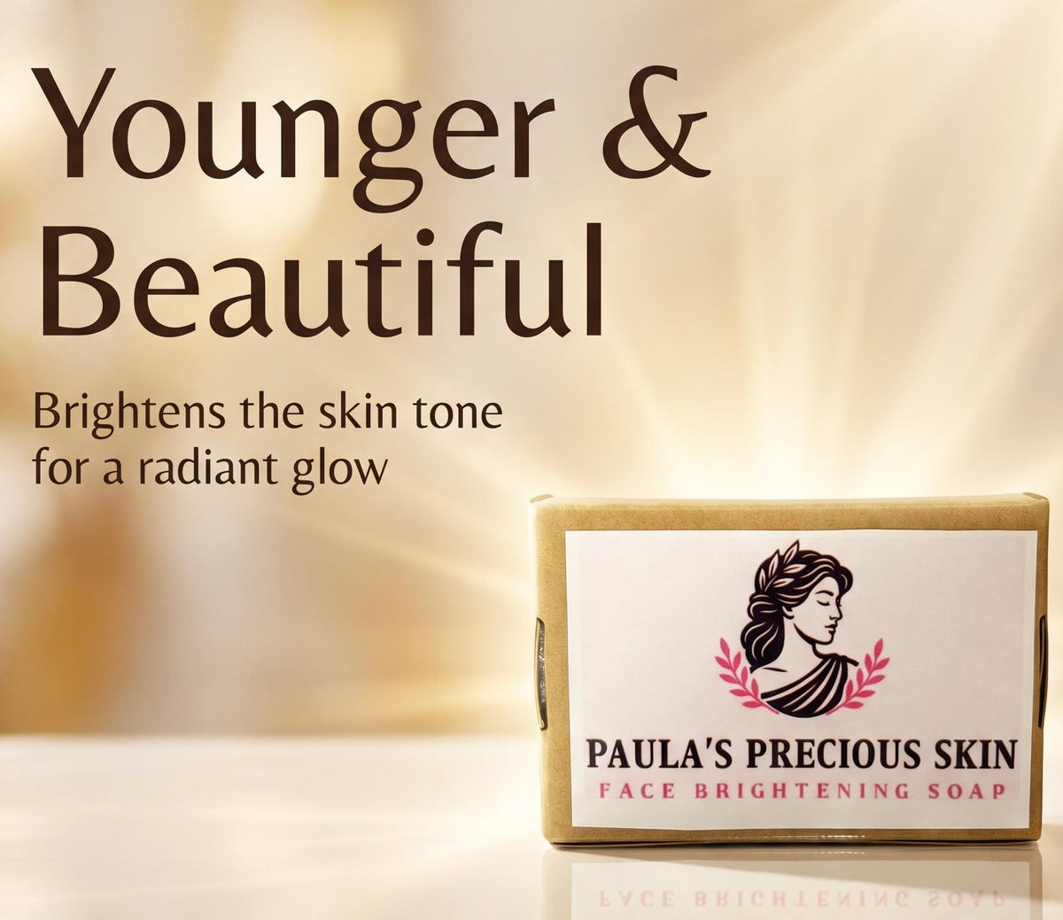 A boxed face brightening soap by Paula's Precious Skin shown on a warm beige background with promotional text reading 'Younger & Beautiful' and 'Brightens the skin tone for a radiant glow.'.