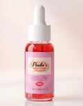 A 30ml dropper bottle of Paula's Brightening Lip Serum filled with pink liquid, set against a soft beige background with text overlays reading 'PINK LIPS SERUM' at the top and 'PREMIUM GLOW & NOURISHING' at the bottom.