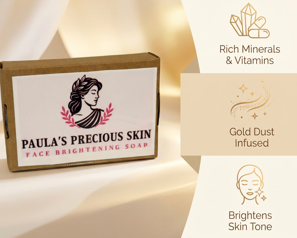 A rectangular cardboard box of Paula's Precious Skin Face Brightening Soap sits on a soft cream-colored surface. The box has a white label with a black profile illustration of a woman, pink leaf accents, and black text reading 'PAULA'S PRECIOUS SKIN FACE BRIGHTENING SOAP.