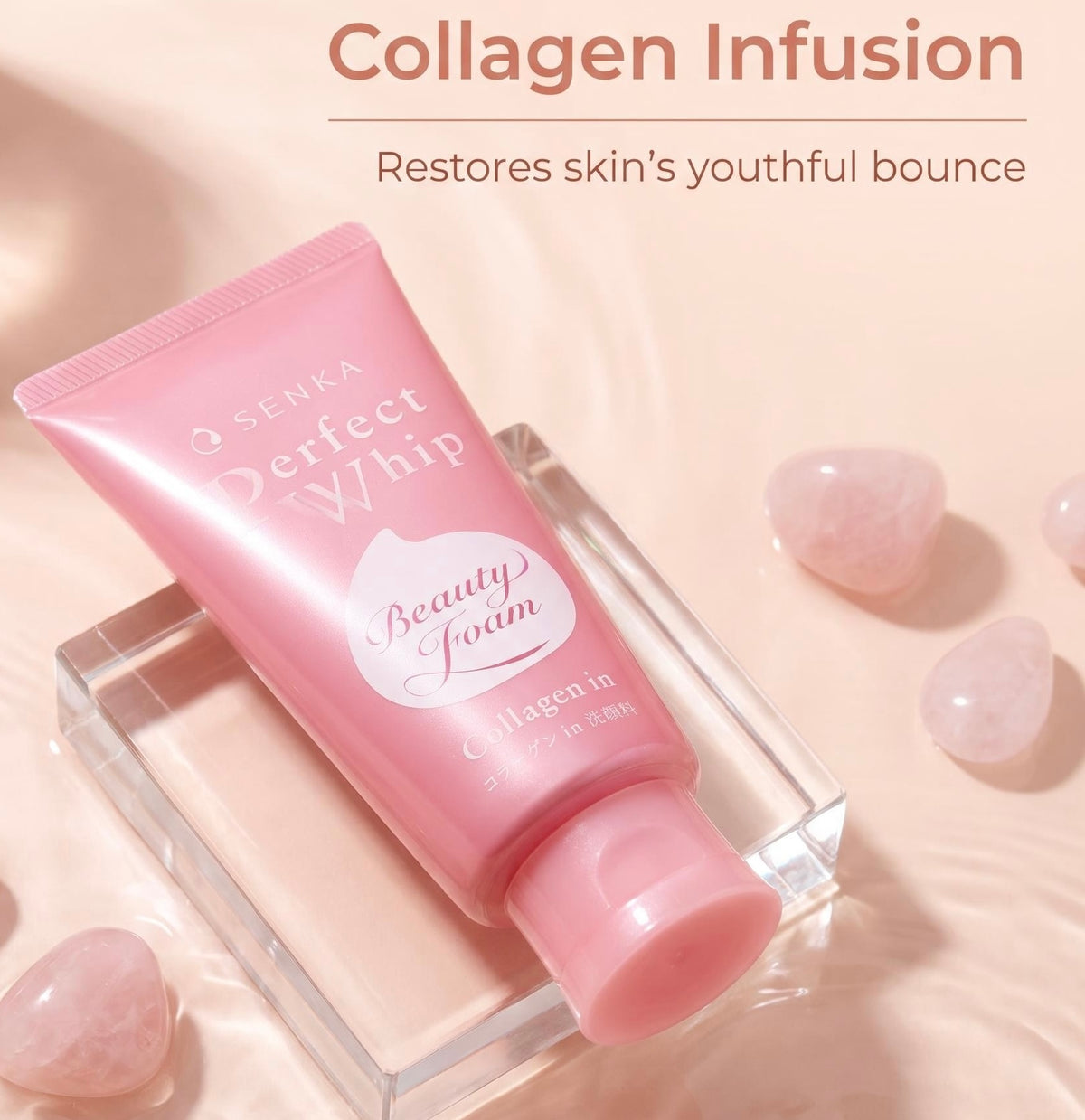 A pink tube of SENKA Perfect Whip Beauty Foam Collagen Infusion skincare product, displayed on a clear acrylic block with pink rose quartz stones on a soft beige background. Text at the top reads 'Collagen Infusion' and 'Restores skin's youthful bounce'.